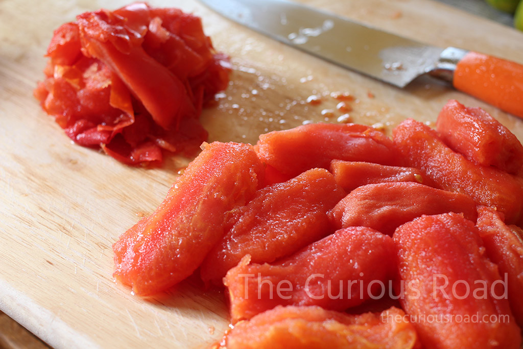 Blanch the tomatoes to remove skins