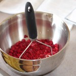 Mashing berries for jam
