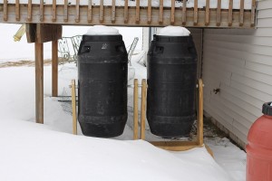 compost tumblers covered in snow